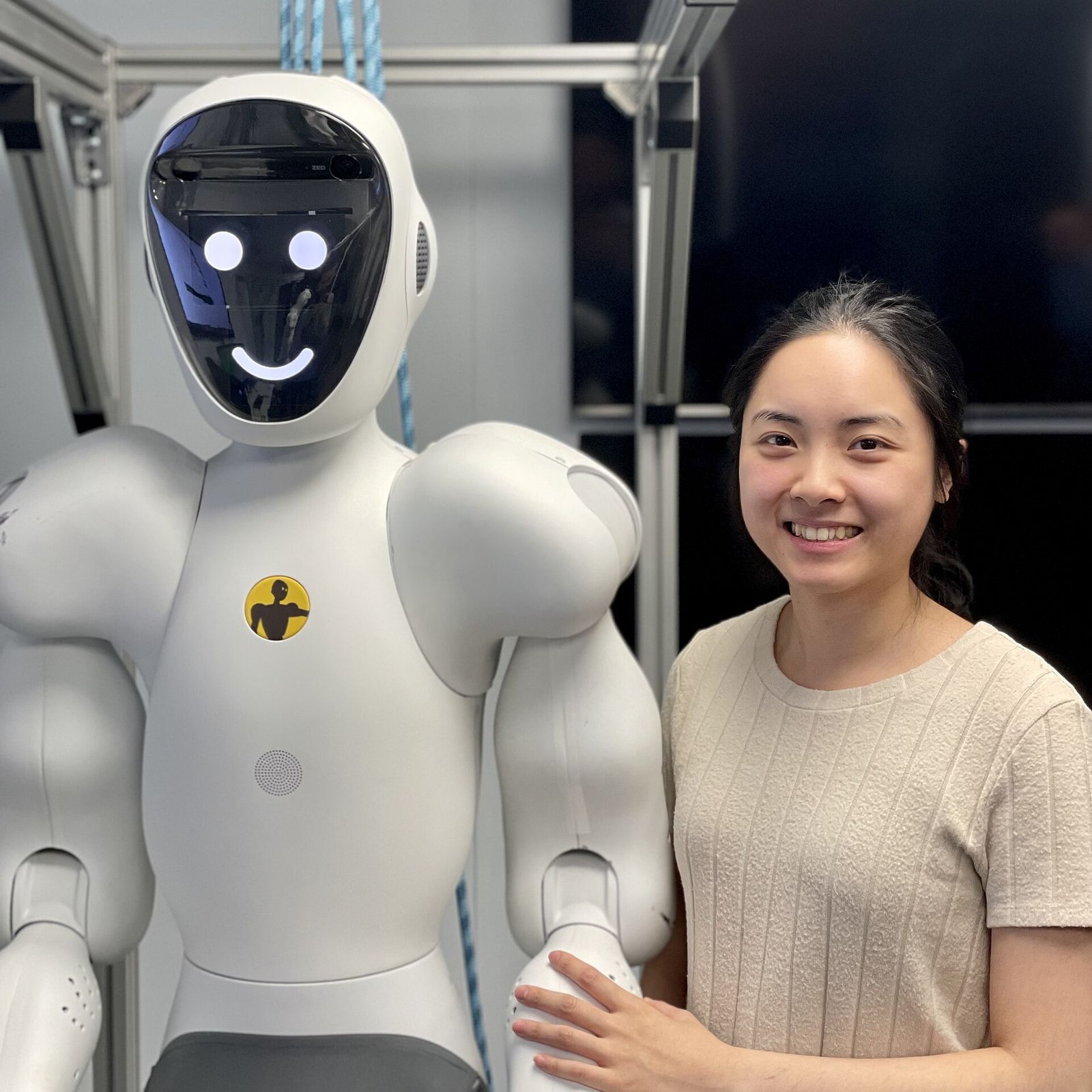An engineer with a humanoid collaborative robot built by Halodi Robotics