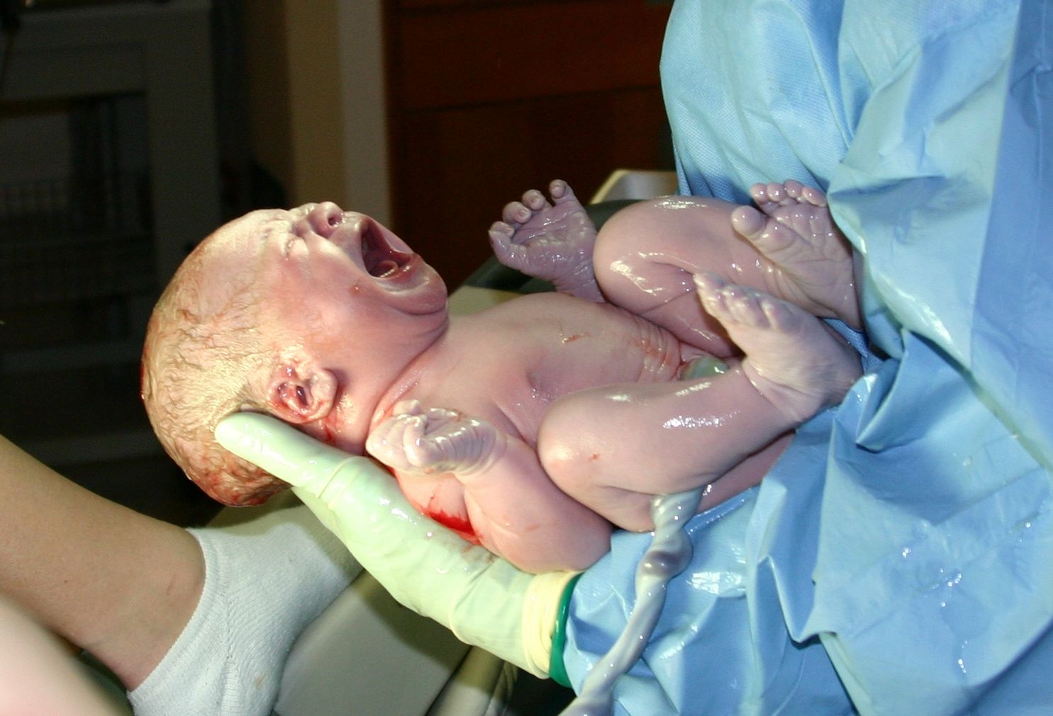 A newborn baby in a hospital nursery